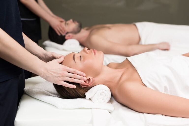 side-view-of-young-couple-having-massage-in-spa-salon.jpg